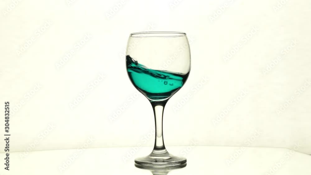 Splash of blue liquid in wine glass Splash of blue liquid in wine glass