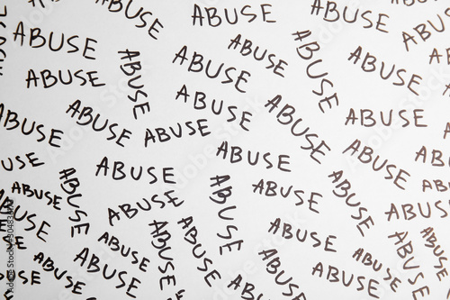 Sheet of paper with words ABUSE, top view. Domestic violence awareness
