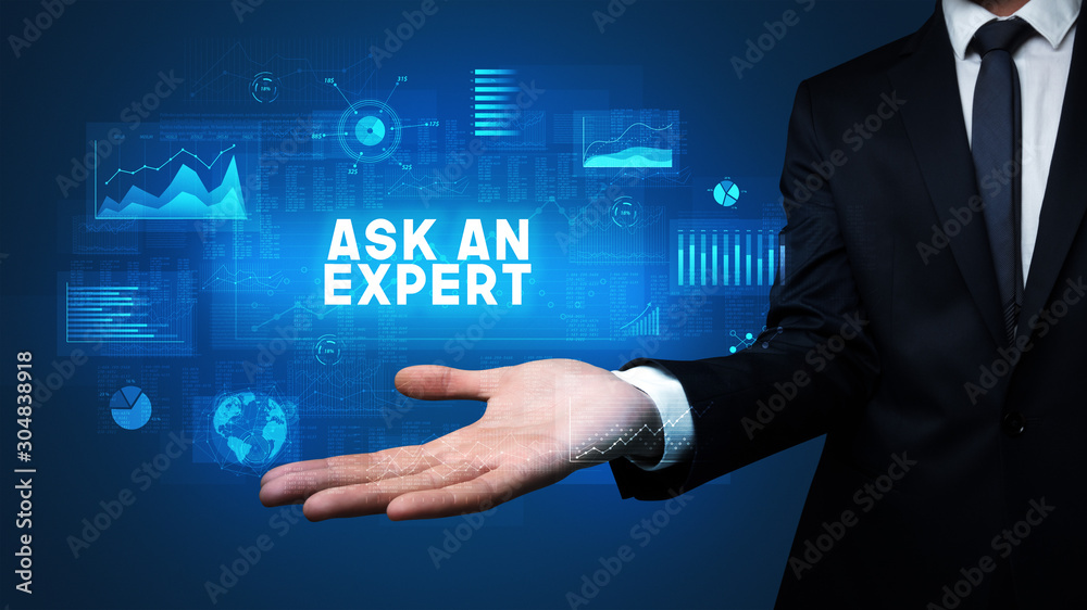 Fototapeta premium Hand of Businessman holding ASK AN EXPERT inscription, business success concept