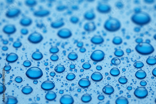 Water drops on blue background  closeup view
