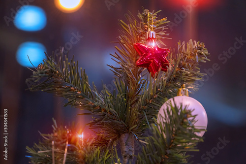 Christmas balls on the Christmas tree branch. Magic lights. Selective focus