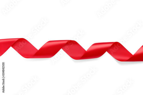 Bright shiny twisted silk red ribbon isolated on white background