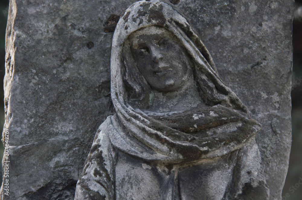 Obraz premium Monument and candles in the cemetery. All Saints Day in Poland.