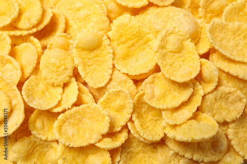 Tasty crispy corn flakes as background  top view