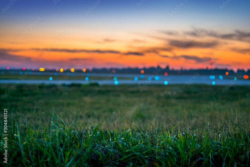 Airport runway in the evening. Blurred background with colorful lights.