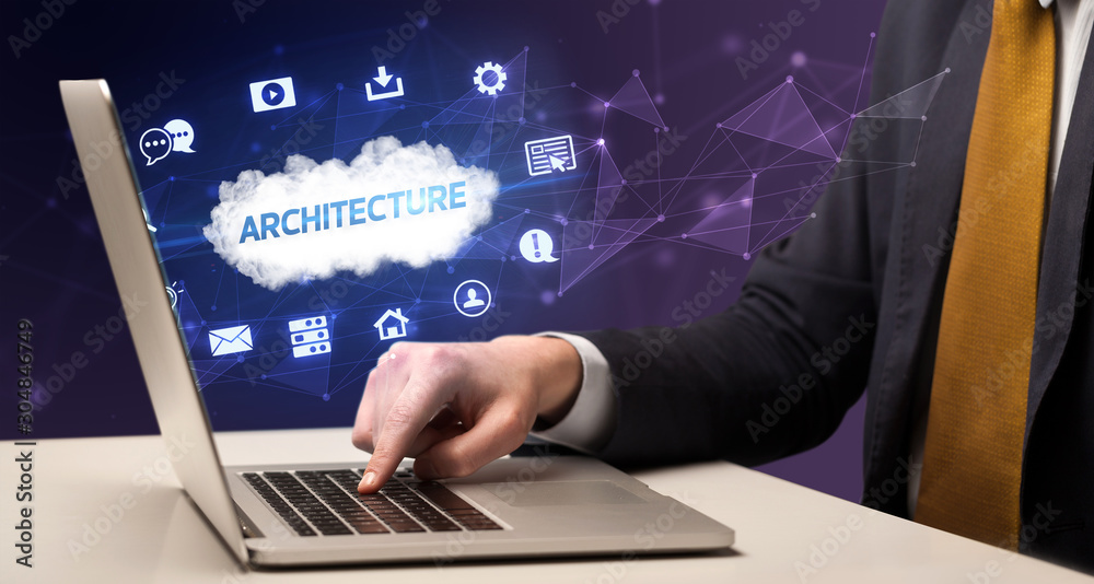 Businessman working on laptop with ARCHITECTURE inscription, modern technology concept Businessman working on laptop with ARCHITECTURE inscription, modern technology concept