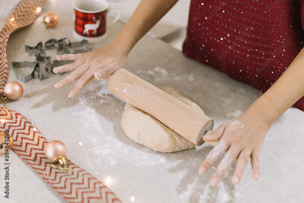 Woman rolling gingerbread dough with rolling pin Woman rolling gingerbread dough with rolling pin