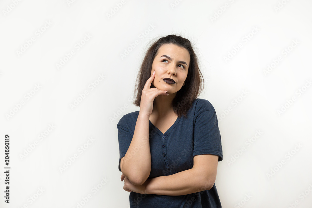 Image of excited young lady with glasses. Looking camera have an idea. Stands on a white background. Image of excited young lady with glasses. Looking camera have an idea. Stands on a white background.