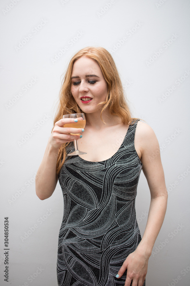 Beautiful long red health hair of young attractive woman isolated white background gray dress posing mockup advertisement drink glass Beautiful long red health hair of young attractive woman isolated white background gray dress posing mockup advertisement drink glass