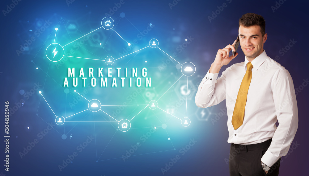 Businessman in front of cloud service icons with MARKETING AUTOMATION inscription, modern technology concept Businessman in front of cloud service icons with MARKETING AUTOMATION inscription, modern technology concept
