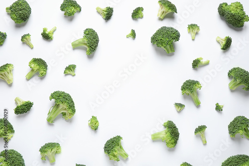 Fresh tasty broccoli on white background, top view