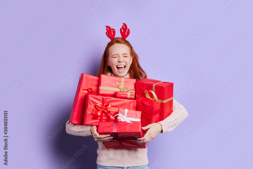 Beautiful caucasian woman with foxy hair, yelling loudly with closed eyes, happy to receive beautiful christmas gifts from family members, fun true emotions, happy celebration of Christmas Beautiful caucasian woman with foxy hair, yelling loudly with closed eyes, happy to receive beautiful christmas gifts from family members, fun true emotions, happy celebration of Christmas