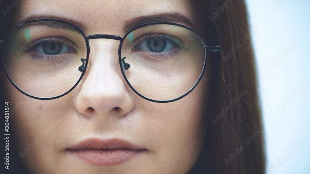 Cropped face of attractive businesswoman in glasses looking at the camera, smiling lovely. Cropped face of attractive businesswoman in glasses looking at the camera, smiling lovely.