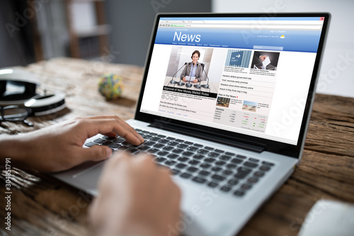 Businessman Reading News On Laptop