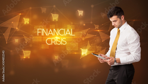Businessman with shopping cart icons and FINANCIAL CRISIS inscription, online shopping concept