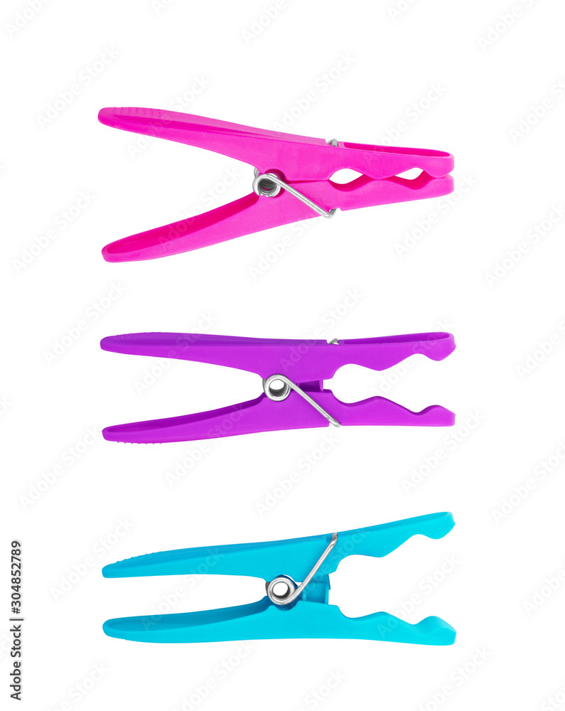 Bright colored plastic clothespins on a white background Bright colored plastic clothespins on a white background