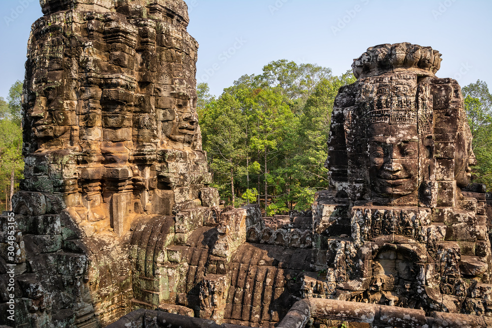 Travel concept. Stone murals and statue Bayon Temple Angkor Thom. Angkor Wat the largest religious monument in the world. Ancient Khmer architecture. Location: Siem Reap, Cambodia. Beauty world.