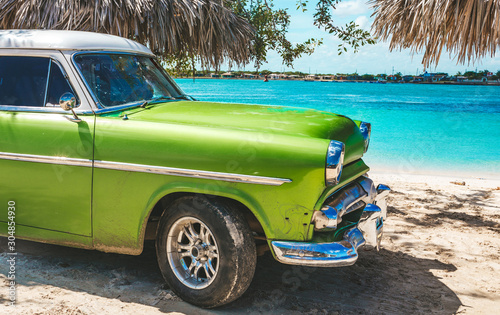 Playa La Herradura, Cuba - October 27, 2019: American classic car on the beach Playa La Herradura, Province Las Tunas, Cuba photo