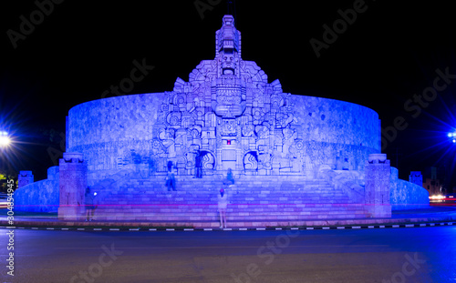 Obraz na plátně Tourist taking photos of the Monument to the Fatherland at night, Yucatan, Mexico