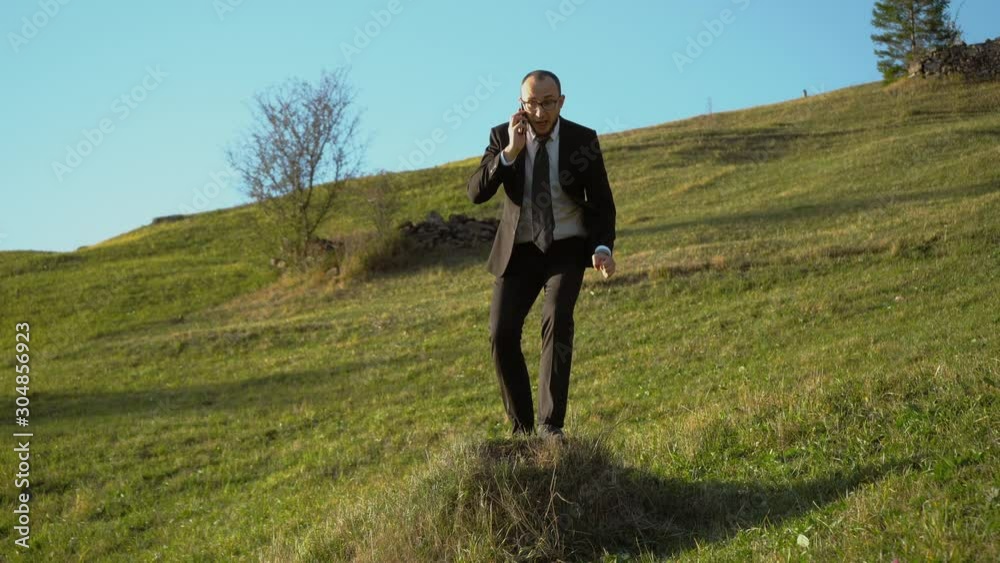 Successful Business Worker Dials A Number On The Phone While On The Mountain Successful Business Worker Dials A Number On The Phone While On The Mountain