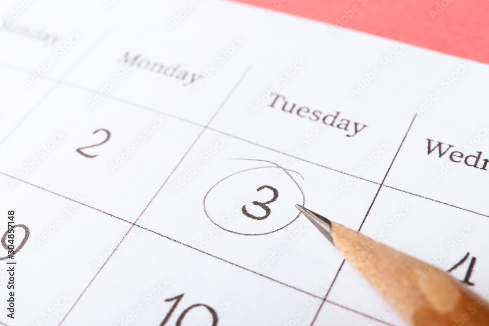 Pencil on calendar page with marked date, closeup Pencil on calendar page with marked date, closeup