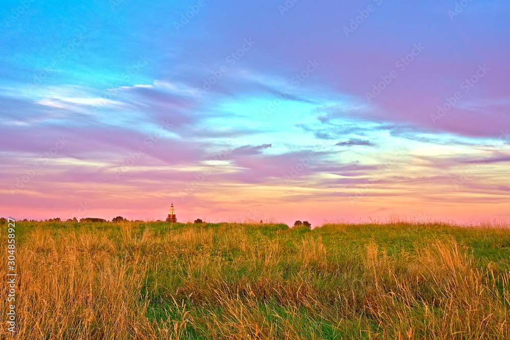 Summer sunset over the field. Kostroma region, Russia.