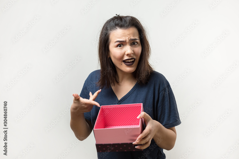 Portrait of a happy smiling girl opening a gift box isolated over white background Portrait of a happy smiling girl opening a gift box isolated over white background