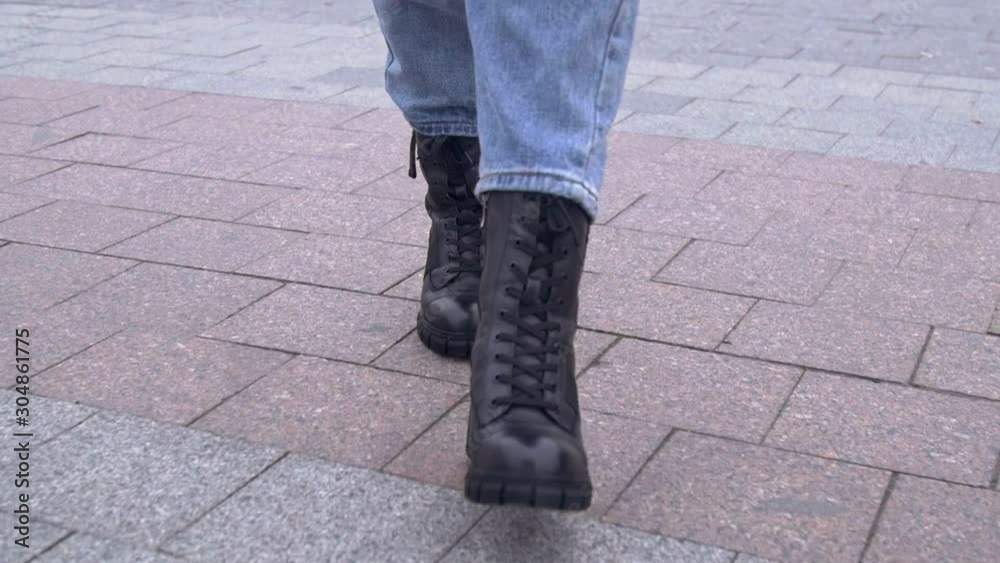 Woman walks in black high winter boots Woman walks in black high winter boots