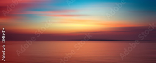 Motion blurred background of sunset on the sea