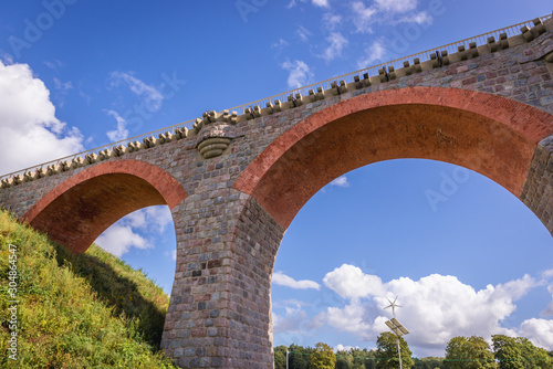 Fototapeta Naklejka Na Ścianę i Meble -  Antique railroad bridge in Glaznoty, small village in Masuria region of Poland