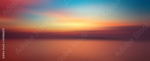 Motion blurred background of sunset on the sea © opasstudio