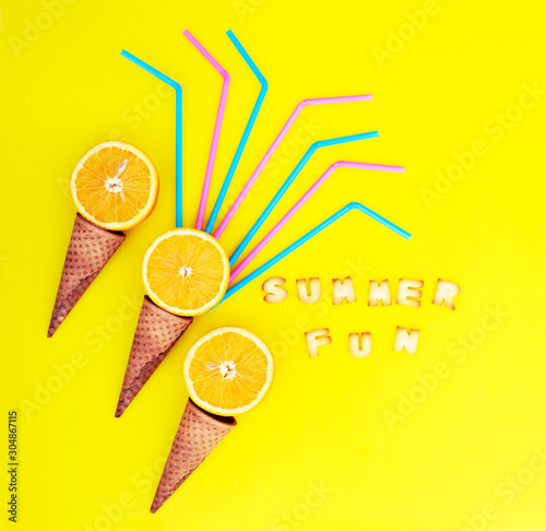 summer concept background with cone and juice oranges photo