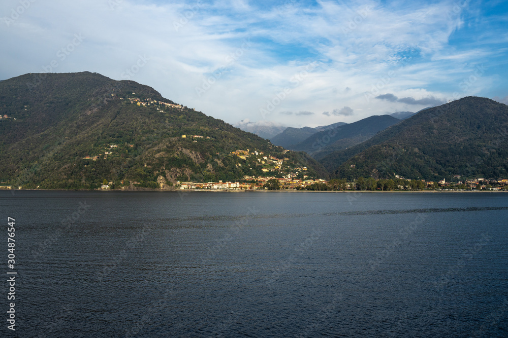 Landscape of Lago Maggiore at sunset from a ferry boat cruising on the lake, Italy