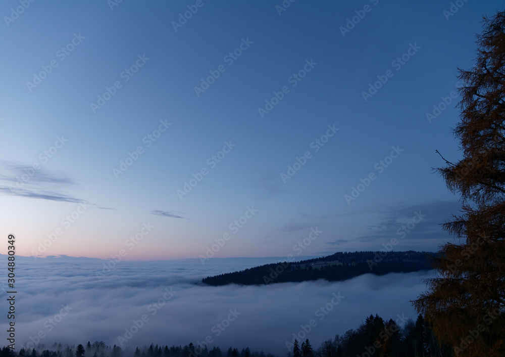 Beautiful sunrise seen from the top of the mountain above clouds