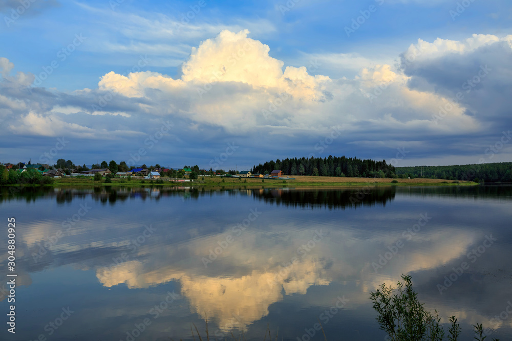 Beautiful summer sunset on the Visimo-Shaitan lake. Visim strict nature reserve. Village of Visim, Sverdlovsk region, Ural mountains, Russia.