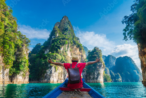 Man traveler on boat joy fun with nature rock mountain island scenic landscape Khao Sok National park, Famous travel adventure place Thailand, Tourism beautiful destinations Asia holiday vacation trip © day2505
