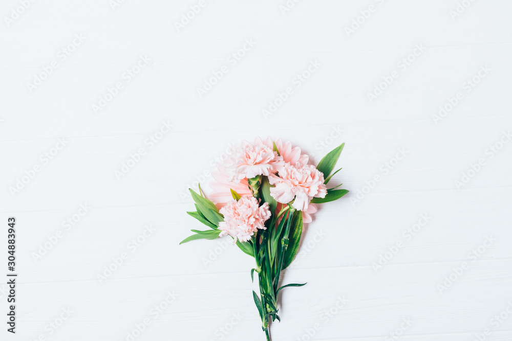 Small bouquet of beautiful pale pink carnations flowers