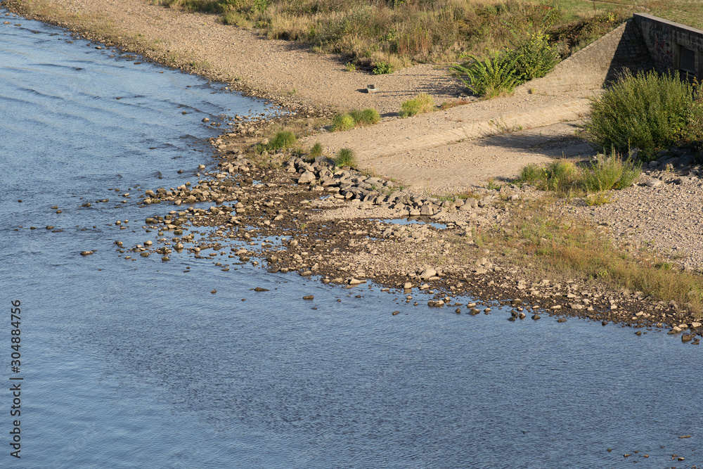 Elbe river beach stone boulders late summer green blue water low level Elbe river beach stone boulders late summer green blue water low level