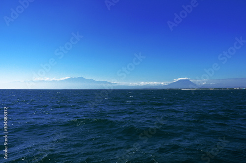 two mountains, sea and blue sky on the java sea