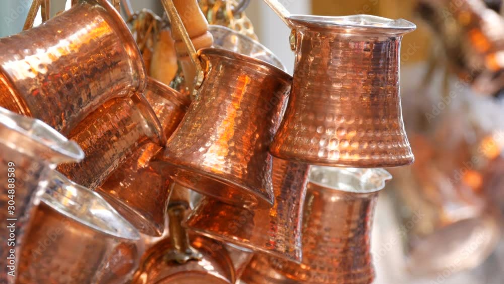 Many beautiful shiny copper coffee turks hang in Istanbul market Many beautiful shiny copper coffee turks hang in Istanbul market