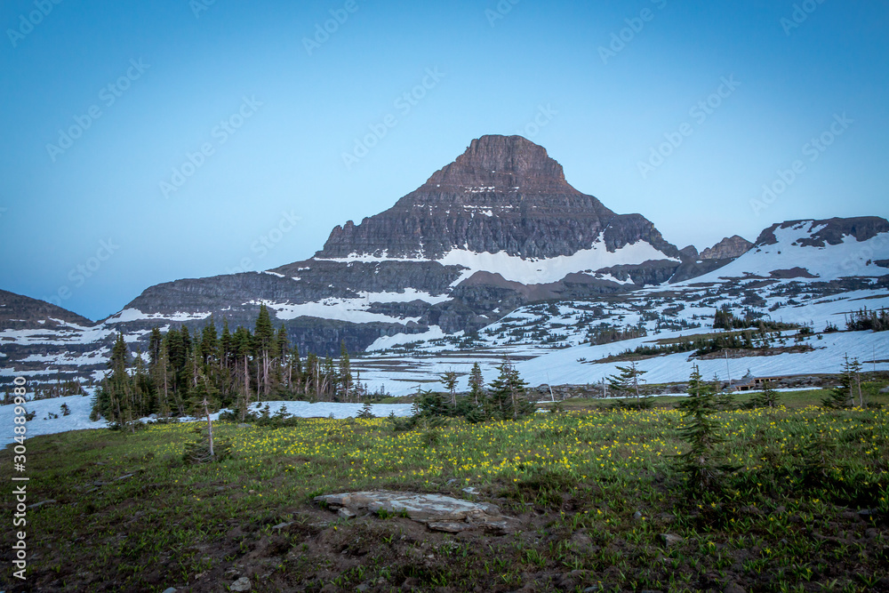 Naklejka premium Peaceful mountain meadow under lonely mountain peak. Beautiful mountain landscape.