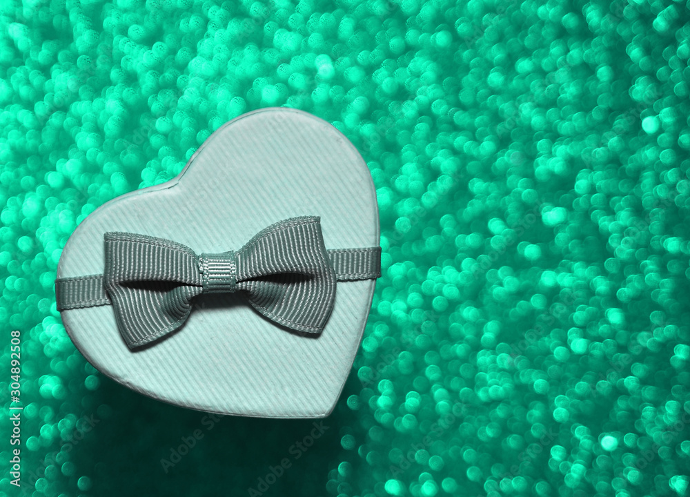 Gift box with ribbon on trendy mint color background. Gift box with ribbon on trendy mint color background.
