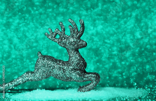 Christmas deer on mint color background.
