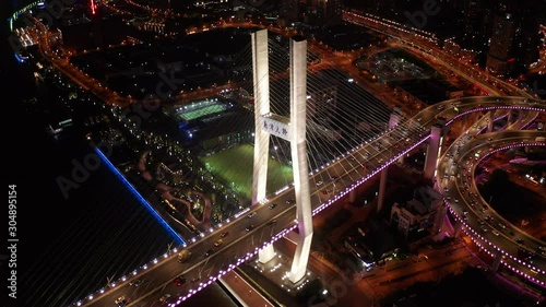 Aerial drone 4k video scene of traffic on Nanpu Spiral road at night, Nanpu bridge, Huangpu River,  Shanghai, China