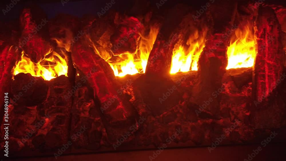 Artificial fireplace with flames and fake fierwood 4k 50fps Artificial fireplace with flames and fake fierwood 4k 50fps