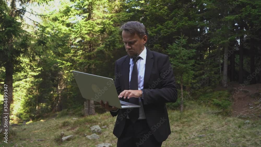 Successful Office Manager Is Working Outdoors On A Laptop And Finishing His Working Day Successful Office Manager Is Working Outdoors On A Laptop And Finishing His Working Day