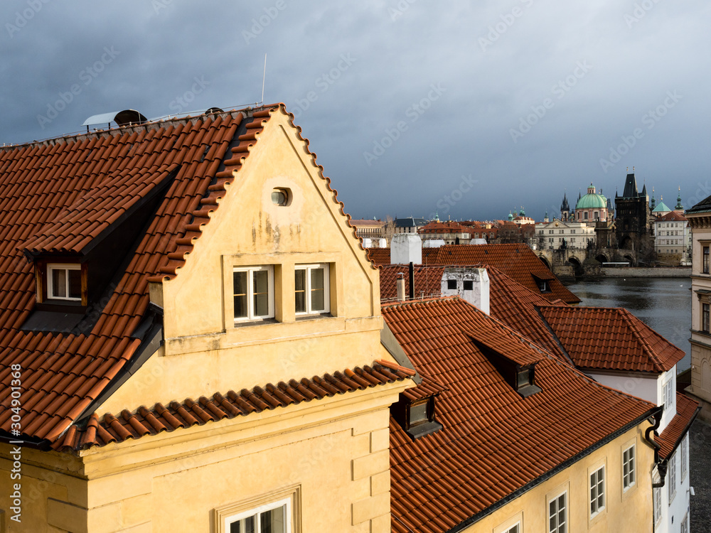 Rooftops of Mala Strana neighborhood with view of Charles Bridge at the background Rooftops of Mala Strana neighborhood with view of Charles Bridge at the background