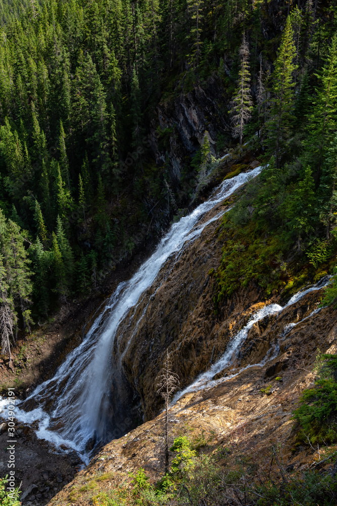 Beautiful View of a waterfall near Grassi Lake during a vibrant summer day. Taken in Canmore, Alberta, Canada.