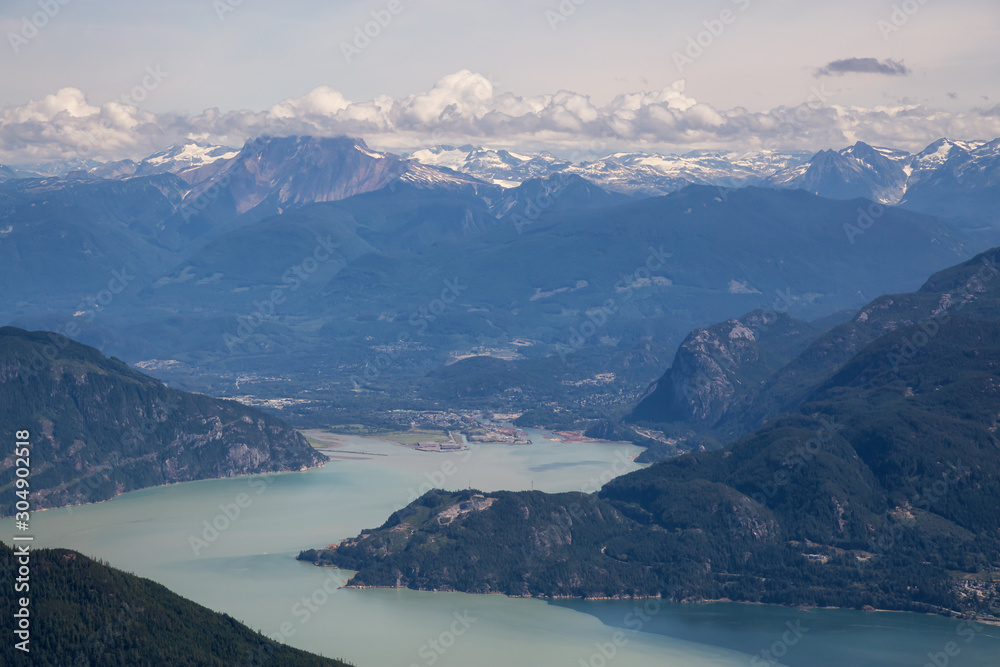 Beautiful Aerial View of Howe Sound Inlet and Squamish City with Canadian Mountain Landscape in background. Taken North of Vancouver, BC, Canada.