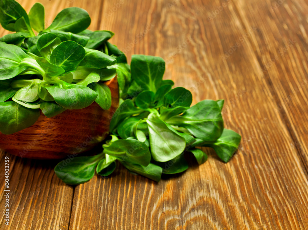 Fresh juicy green corn salad in a wooden bowl on a wooden background. Text space. Fresh juicy green corn salad in a wooden bowl on a wooden background. Text space.